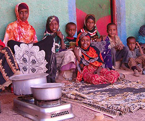 Somali refugee family cooks with CleanCook ethanol stove.